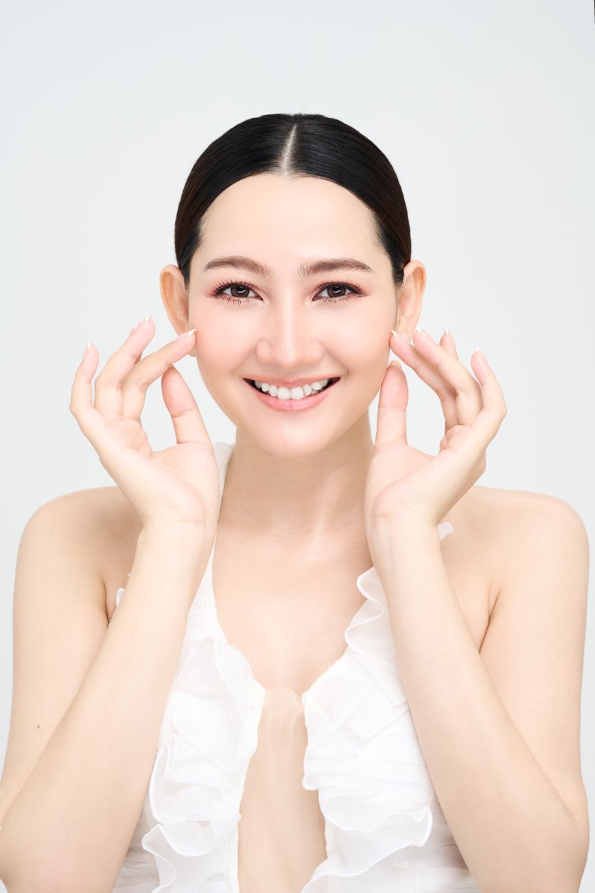 A woman with clear, healthy skin in a clean studio portrait
