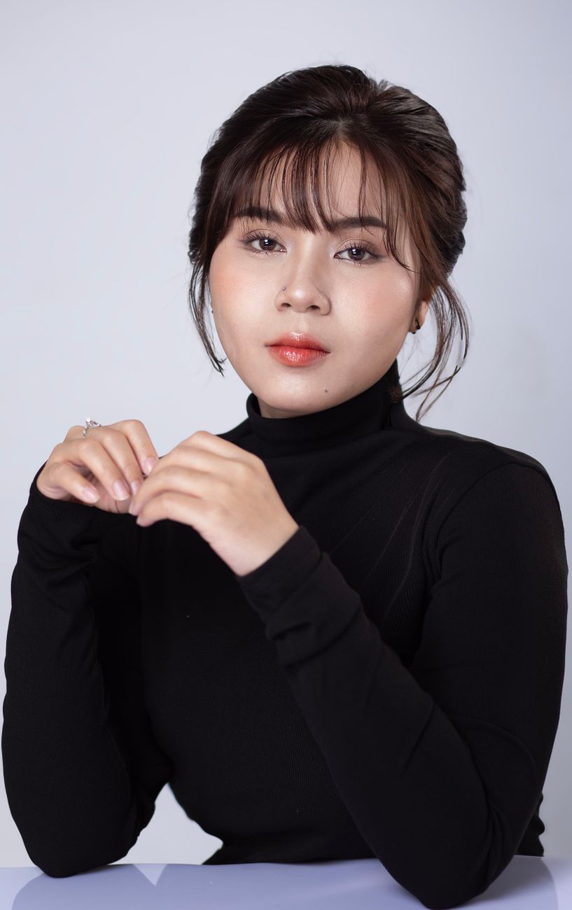A clean studio portrait of a woman with clear, healthy skin