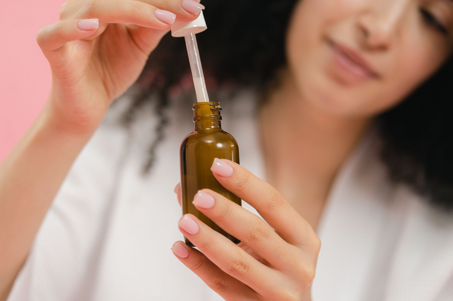 A close-up of a dropper and a serum bottle, representing skin booster treatments