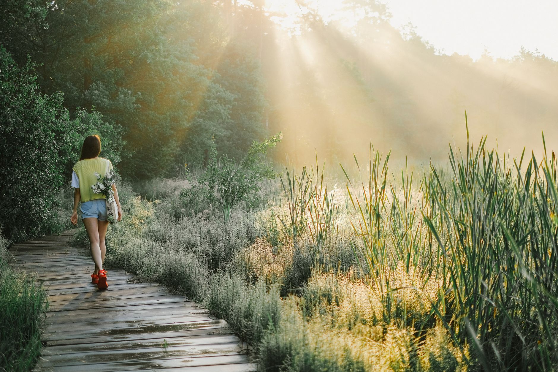 A woman walking outdoors in the morning light, representing a healthy, active lifestyle